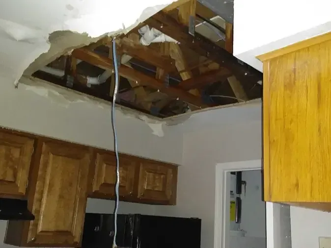 Kitchen ceiling opened up after water came down from the floor above