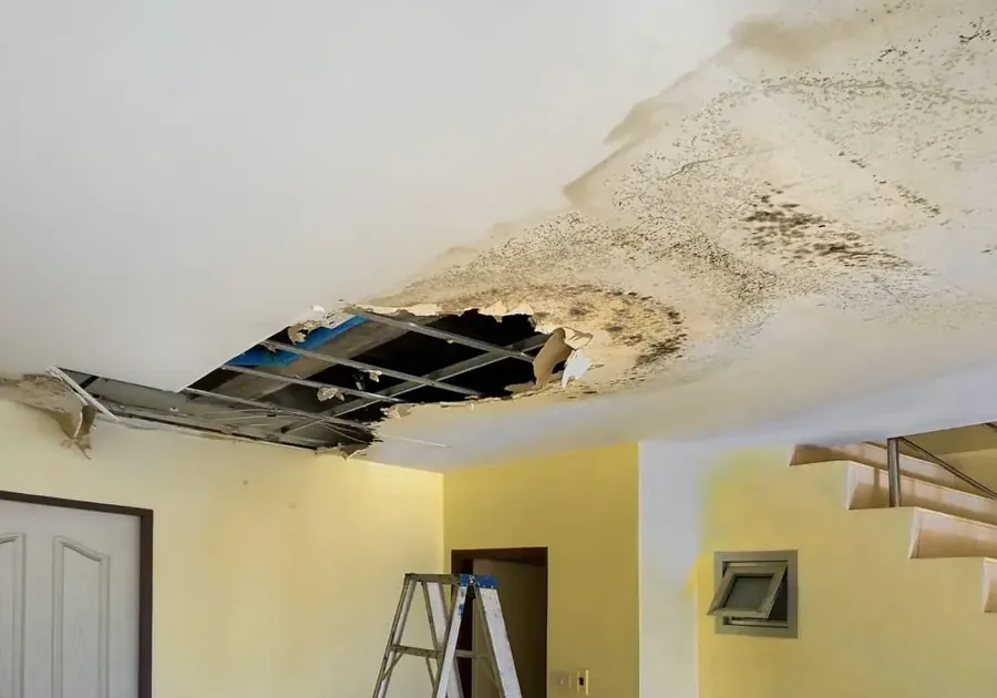 Water-stained and sagging ceiling inside a house after a leak